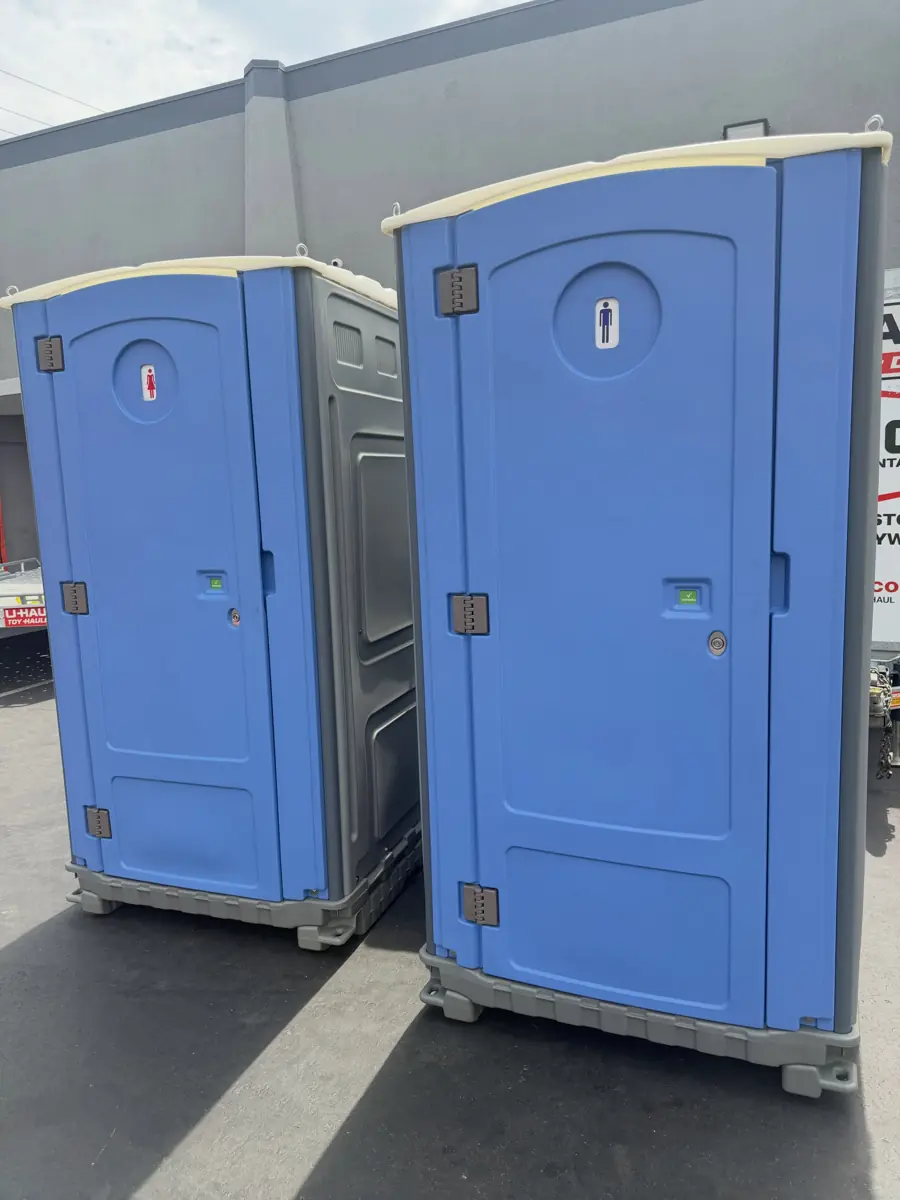 Two standard blue porta potties with roof vents